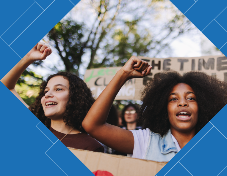 Two young people marching in a protest