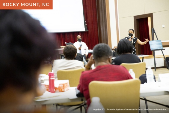 Two Black speakers give a presentation to a group of Rocky Mount citizens